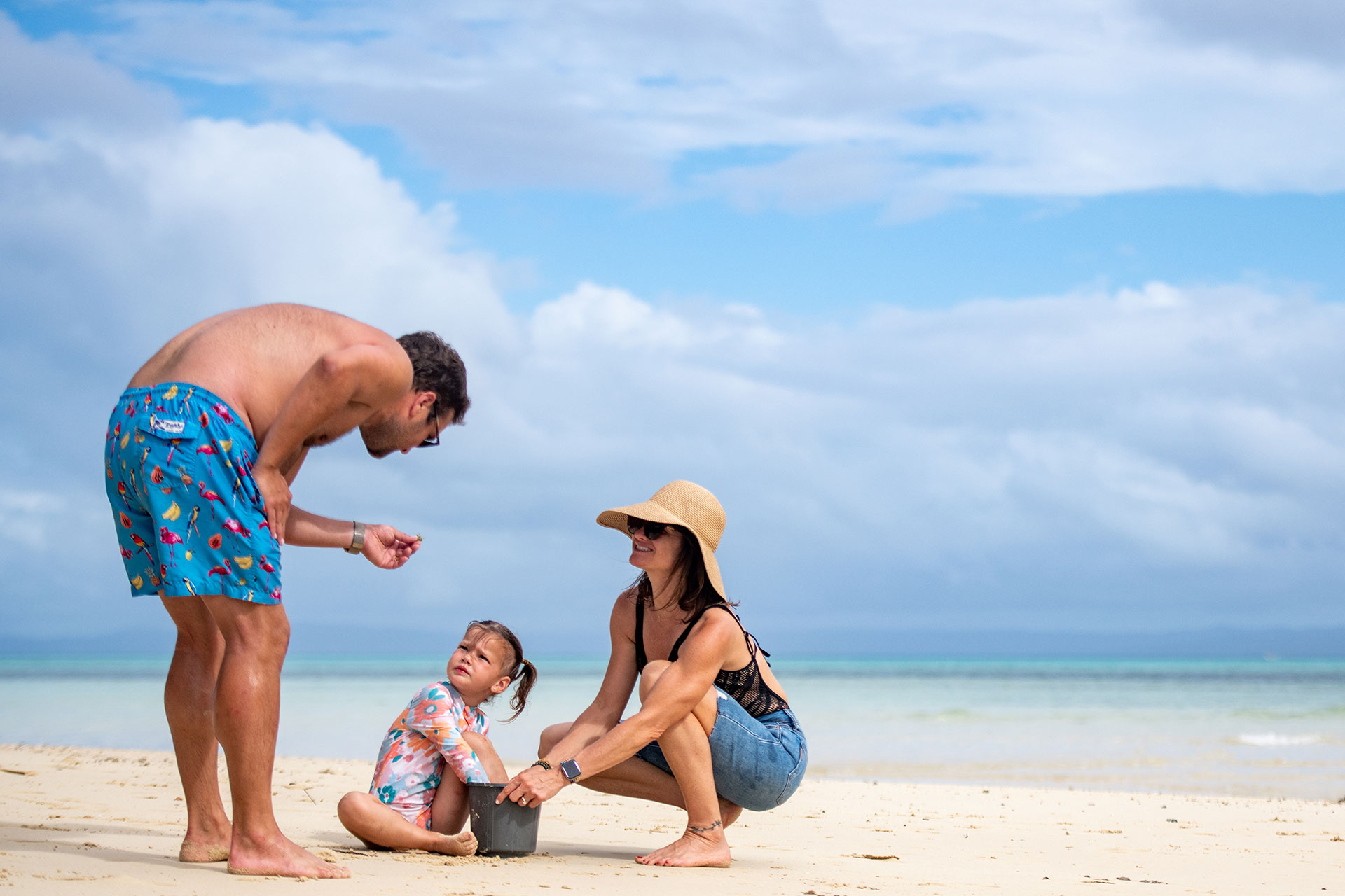 3-Private-Island-Fiji--Luxury-Travel A family at the beachside of the Private Island at JMCR Fiji