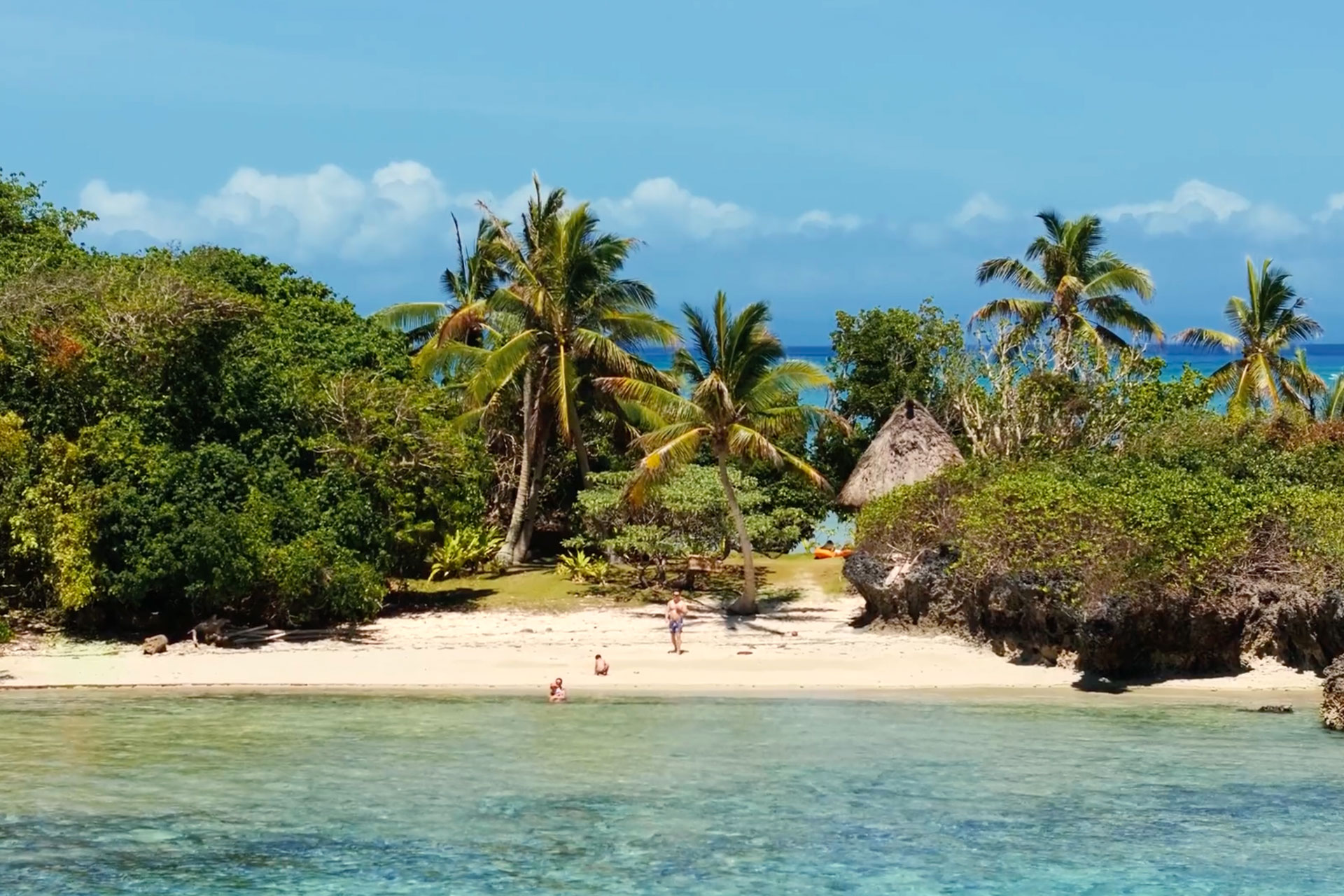Families-3-luxury-family-vacation-in-fiji An image of a family enjoying the JMCR Private island as part of their eco luxury family vacation in Fiji.