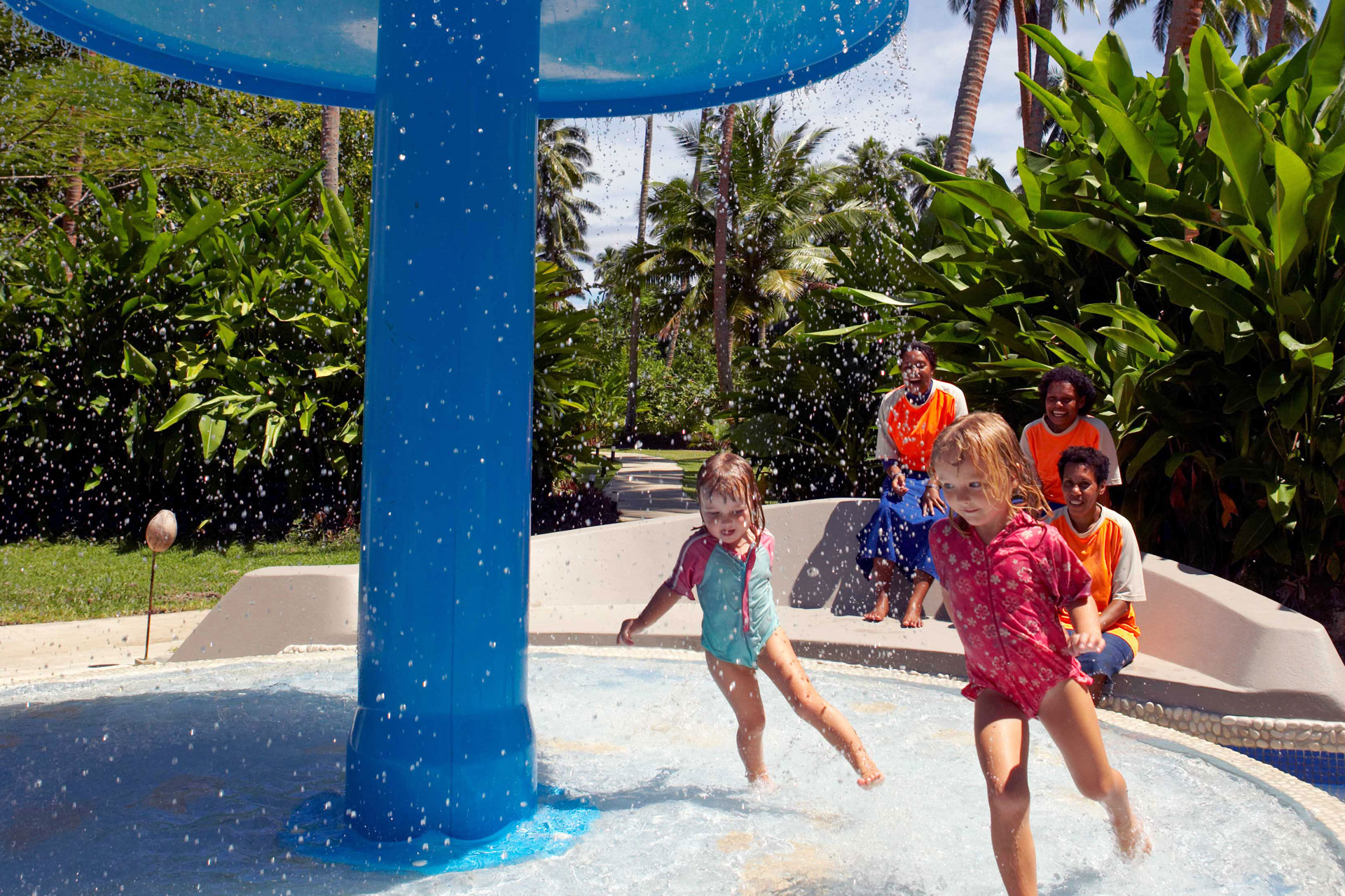 Family-Experiences-3-Fiji-Family-Resort An image of dedicated nannies onlooking little kids entertaining themselves at the Kids Club with fun water activities